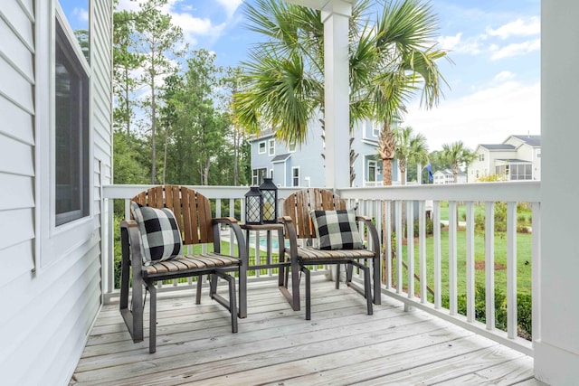 wooden terrace featuring a lawn