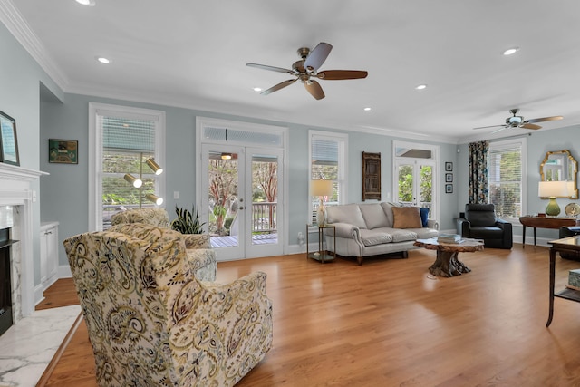 living room with ceiling fan, light hardwood / wood-style flooring, and french doors