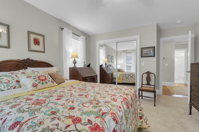 bedroom with light colored carpet and a closet