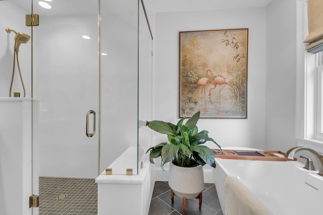 bathroom featuring tile patterned flooring, separate shower and tub, and sink