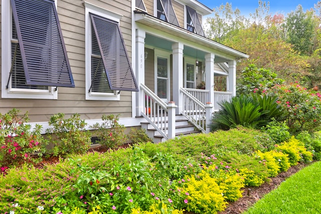 view of exterior entry featuring covered porch