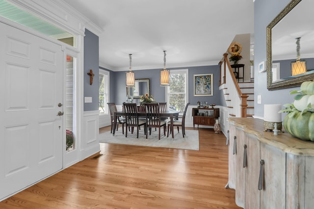 entrance foyer featuring hardwood / wood-style flooring and ornamental molding