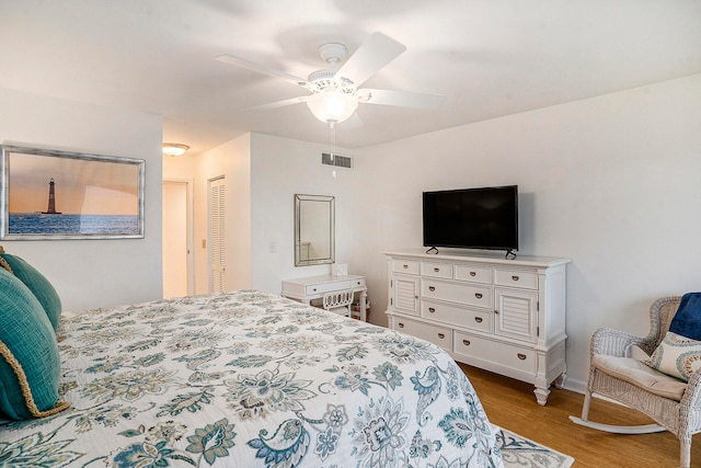 bedroom featuring a closet, light wood-type flooring, and ceiling fan