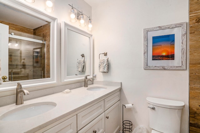 bathroom with walk in shower, vanity, and toilet