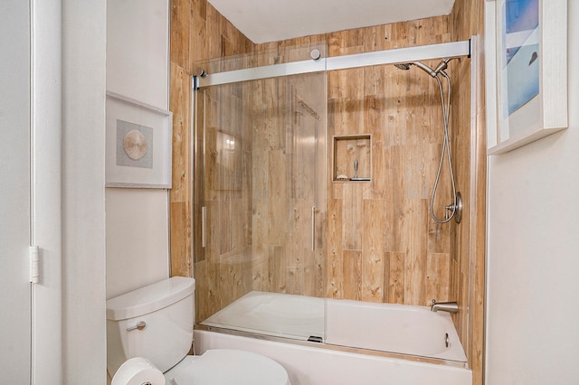 bathroom featuring shower / bath combination with glass door and toilet