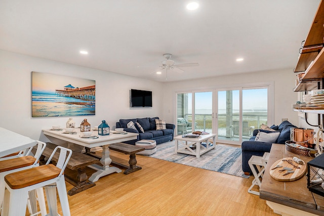 living room with hardwood / wood-style flooring and ceiling fan