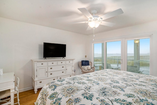 bedroom featuring access to outside, light hardwood / wood-style flooring, and ceiling fan