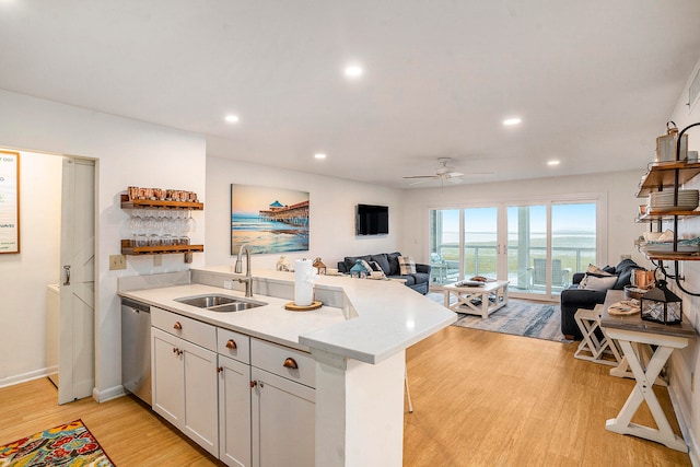 kitchen featuring white cabinetry, sink, ceiling fan, light wood-type flooring, and dishwasher