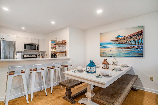 dining room with light hardwood / wood-style flooring