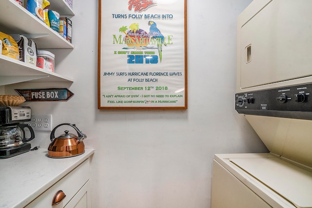 laundry area featuring stacked washer / dryer