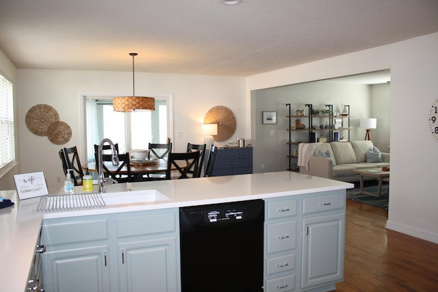 kitchen featuring sink, dishwasher, hanging light fixtures, white cabinets, and dark wood-type flooring