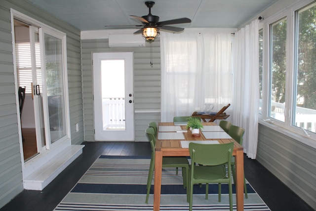 sunroom with ceiling fan, an AC wall unit, and plenty of natural light