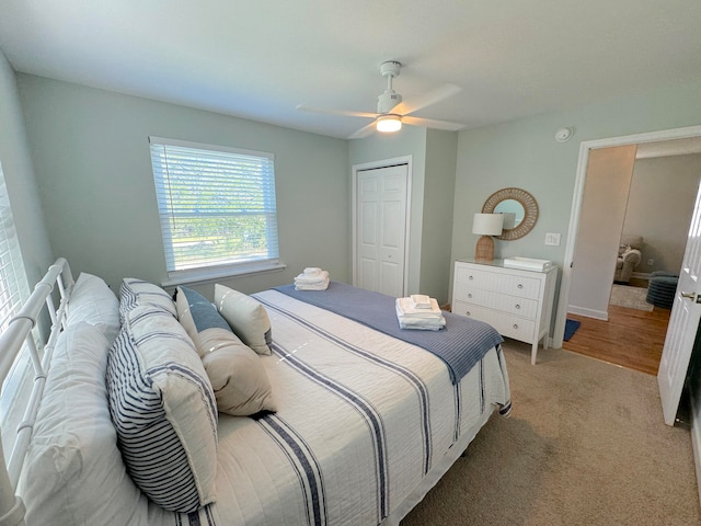 carpeted bedroom featuring a closet and ceiling fan