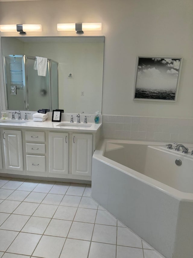 bathroom with vanity, independent shower and bath, and tile patterned floors