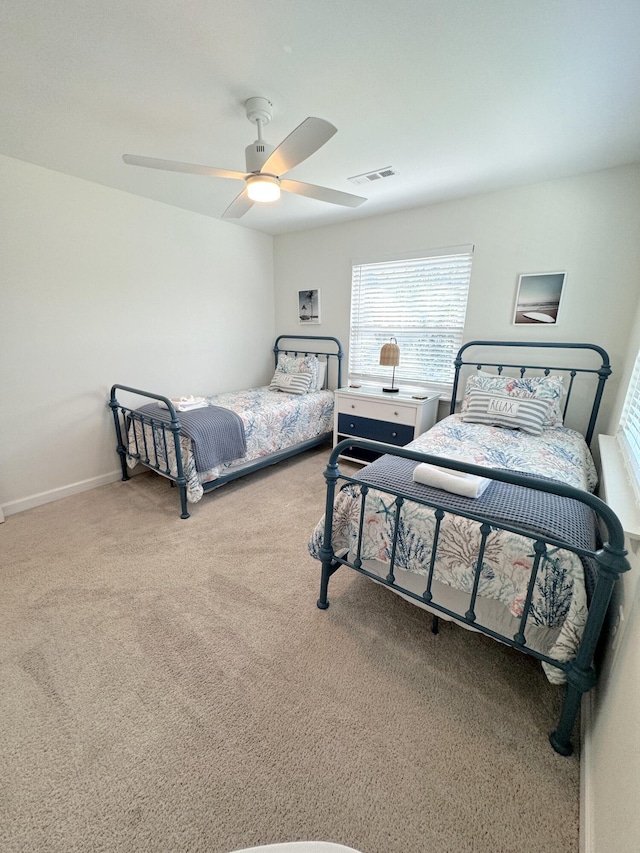 32 41st Ave, Isle Of Palms, SC 29451 - carpeted bedroom featuring multiple windows, a ceiling fan, and baseboards