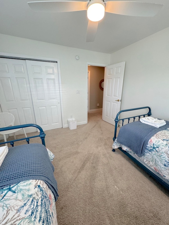 carpeted bedroom with a closet and ceiling fan