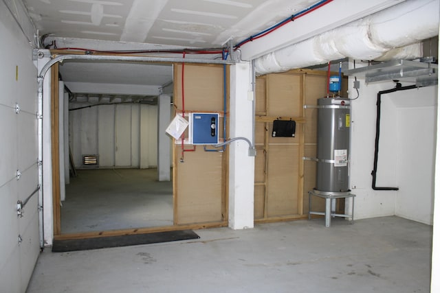 basement featuring electric panel and secured water heater