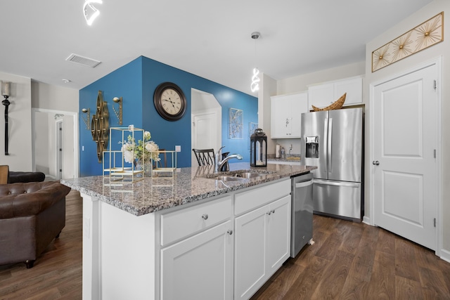 225 N Light Way, Summerville, SC 29486 - kitchen with appliances with stainless steel finishes, dark wood-type flooring, open floor plan, light stone countertops, and an island with sink
