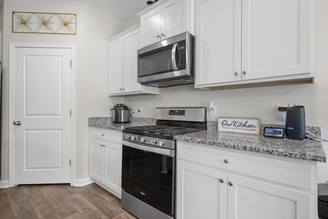 225 N Light Way, Summerville, SC 29486 - kitchen with stainless steel appliances, dark wood-style floors, light stone countertops, and white cabinets