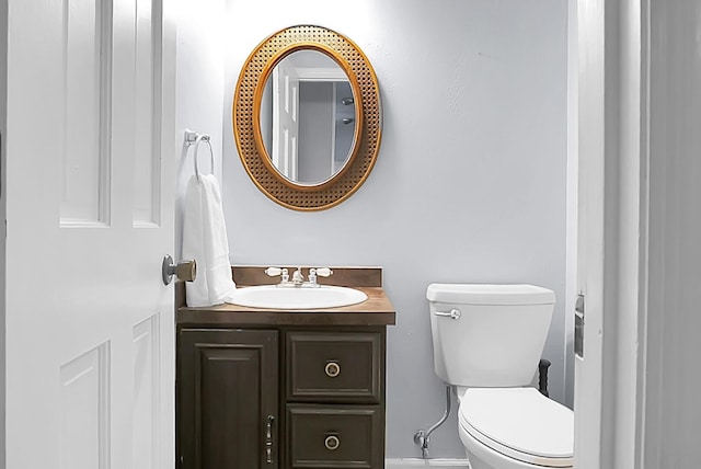 bathroom featuring toilet and vanity