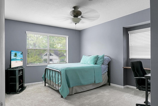 bedroom featuring carpet floors, a textured ceiling, and baseboards