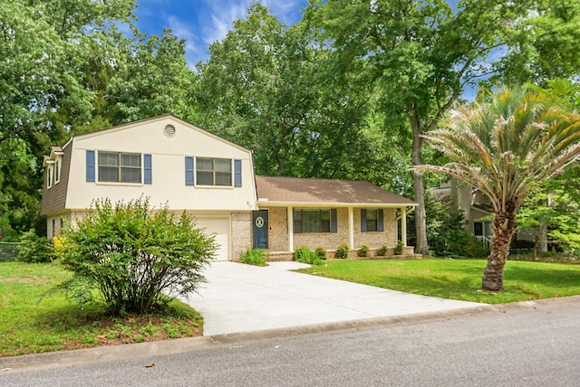 split level home featuring an attached garage, driveway, brick siding, and a front yard