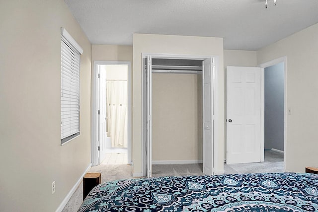 bedroom featuring baseboards, carpet flooring, and a closet