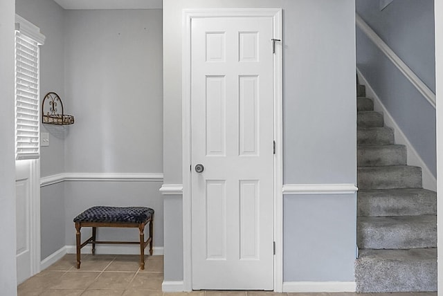 staircase with tile patterned floors and baseboards