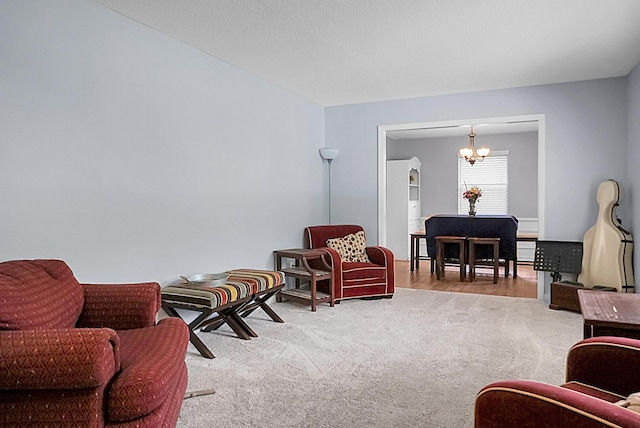 carpeted living area featuring a notable chandelier