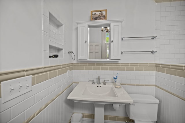 41 Legare St Unit C, Charleston, SC 29401 - half bathroom featuring toilet, tile walls, and a sink