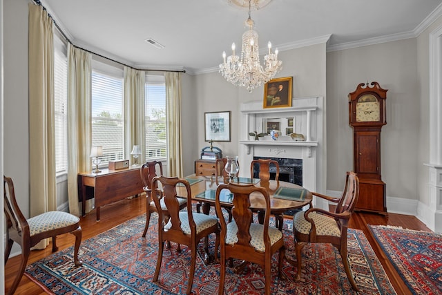 41 Legare St Unit C, Charleston, SC 29401 - dining space with wood finished floors, a premium fireplace, crown molding, baseboards, and a chandelier