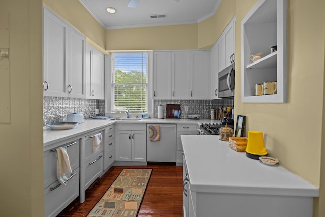 41 Legare St Unit C, Charleston, SC 29401 - kitchen featuring appliances with stainless steel finishes, crown molding, dark wood-type flooring, and white cabinetry