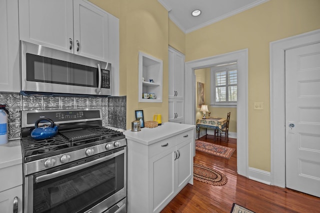 41 Legare St Unit C, Charleston, SC 29401 - kitchen with appliances with stainless steel finishes, crown molding, light countertops, white cabinets, and dark wood-style flooring