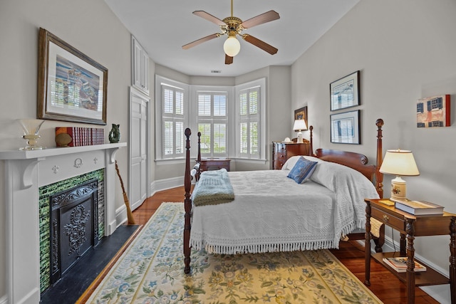 41 Legare St Unit C, Charleston, SC 29401 - bedroom featuring baseboards, a tile fireplace, dark wood-style floors, and ceiling fan