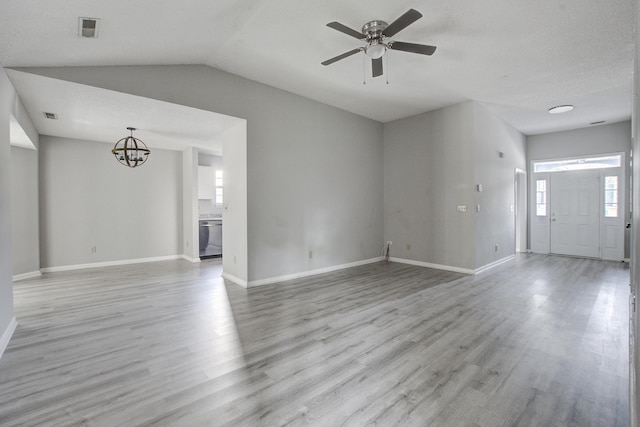 unfurnished living room featuring vaulted ceiling, visible vents, baseboards, light wood-style flooring, and ceiling fan with notable chandelier