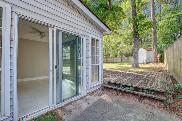 exterior space featuring a fenced backyard, an outdoor structure, a deck, and a shed
