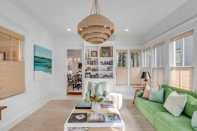 living room featuring crown molding and a chandelier