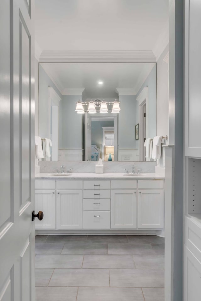 bathroom with crown molding and vanity