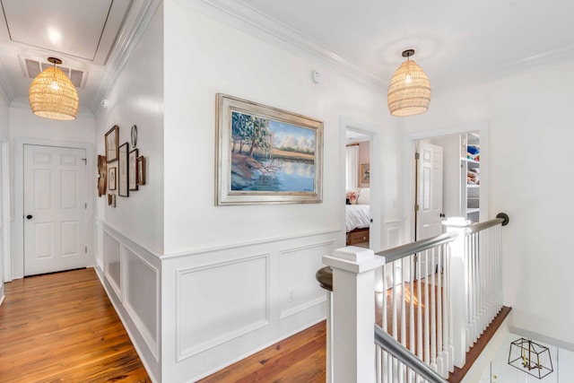 hallway featuring wood-type flooring and ornamental molding