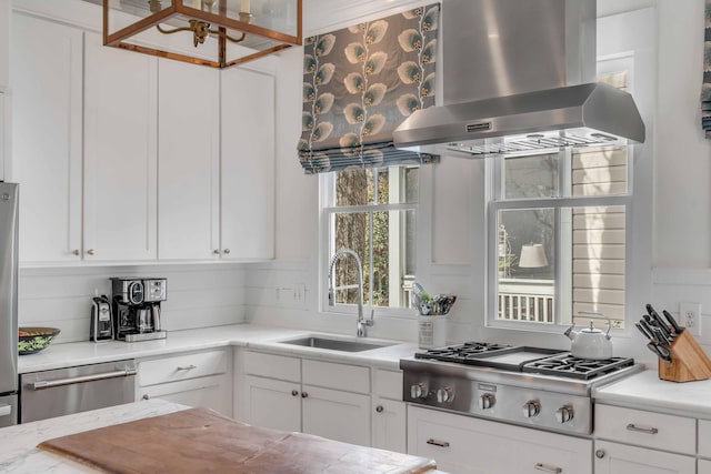 kitchen featuring sink, white cabinets, and island exhaust hood