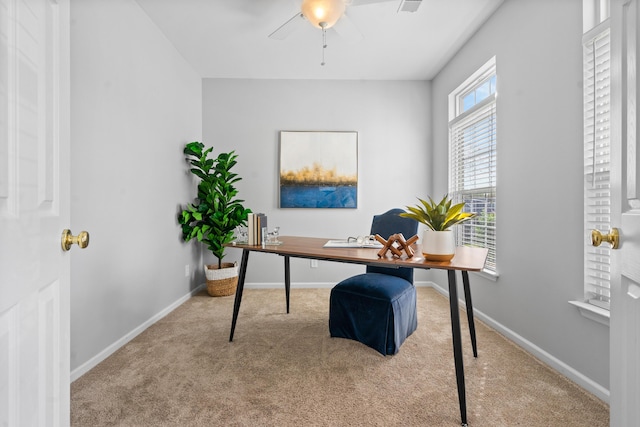 carpeted office featuring ceiling fan