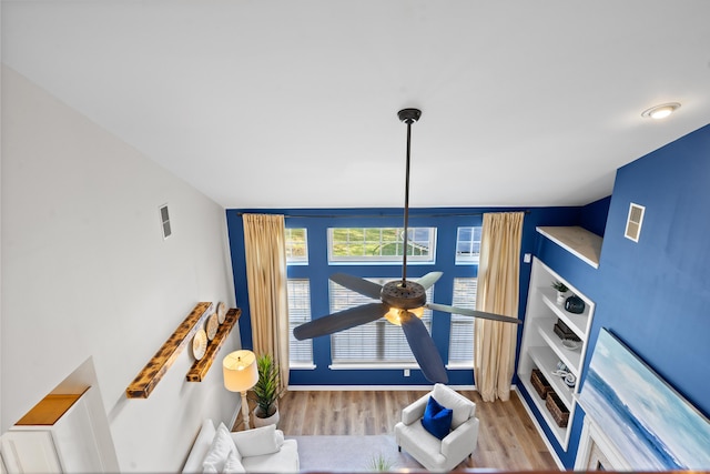 interior details featuring wood-type flooring and ceiling fan