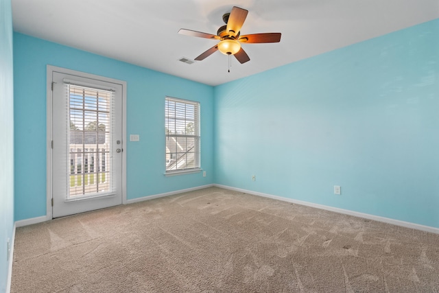 carpeted empty room featuring ceiling fan