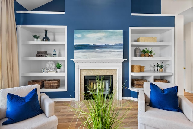 living room with hardwood / wood-style floors and built in shelves