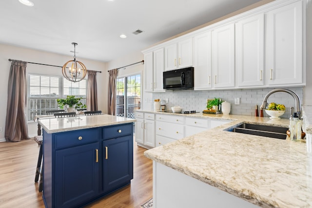 kitchen with light hardwood / wood-style floors, blue cabinets, black appliances, sink, and white cabinetry