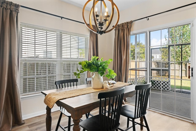 dining room with a chandelier and light hardwood / wood-style floors