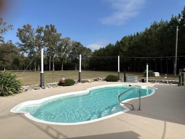 outdoor pool with a patio area