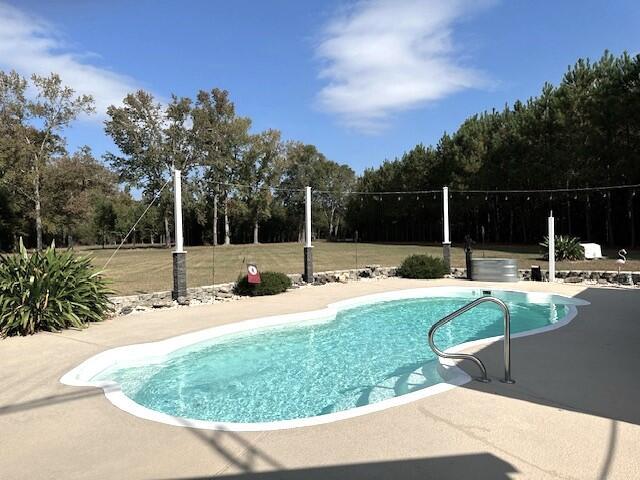 outdoor pool with a patio area