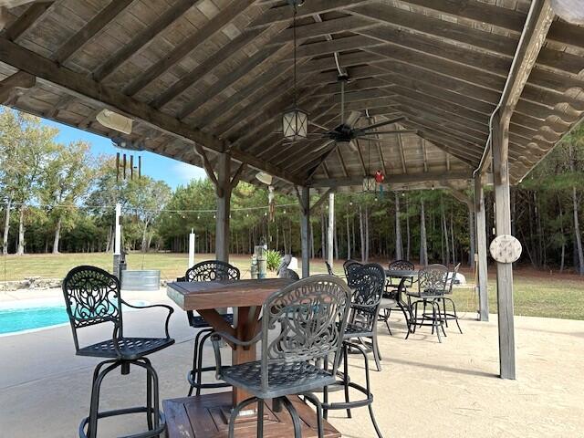 view of patio with a gazebo and outdoor dining area