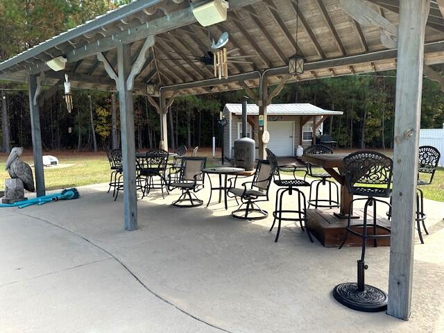 surrounding community featuring a gazebo, an outdoor structure, and a patio